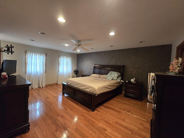 bedroom with ceiling fan and light hardwood / wood-style floors