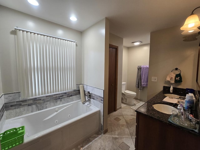 bathroom with vanity, toilet, and a bath