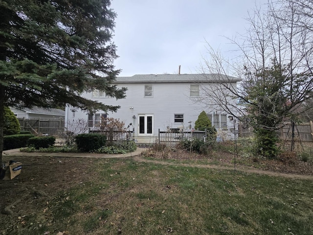 back of house with a yard and a deck