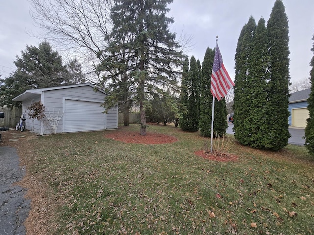 view of yard featuring a garage and an outdoor structure