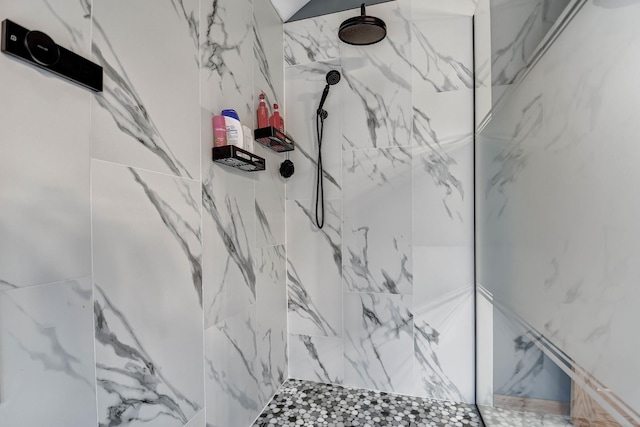 interior details featuring a tile shower