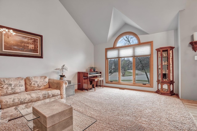 carpeted living room featuring high vaulted ceiling and plenty of natural light