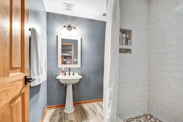 bathroom featuring curtained shower and sink