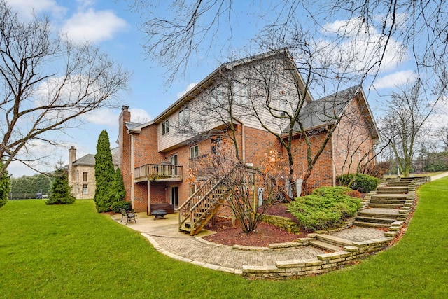 back of property featuring a yard, a deck, and a patio