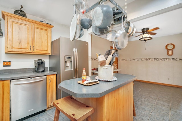 kitchen featuring light brown cabinetry, stainless steel appliances, tile patterned floors, and ceiling fan