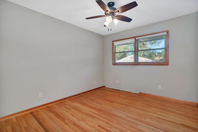 empty room featuring light wood-type flooring and ceiling fan