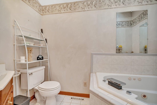 bathroom with vanity, tile patterned flooring, a relaxing tiled tub, and toilet