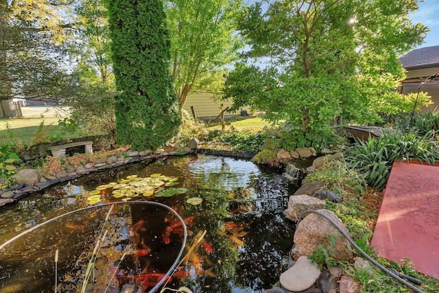 view of yard featuring a garden pond