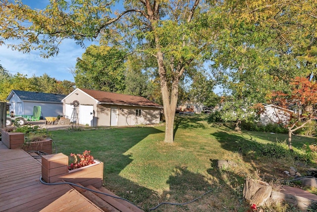 view of yard featuring an outdoor structure and a deck