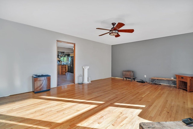 unfurnished living room featuring hardwood / wood-style floors and ceiling fan