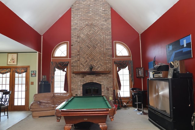 rec room featuring light carpet, a fireplace, high vaulted ceiling, and billiards