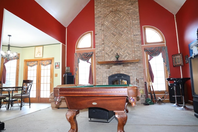 recreation room with carpet flooring, a fireplace, high vaulted ceiling, and french doors