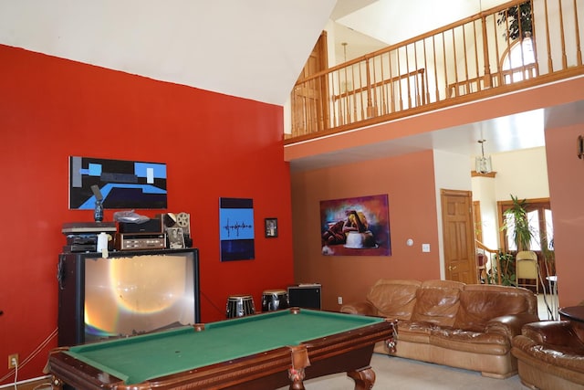 game room with a wealth of natural light, a towering ceiling, and pool table