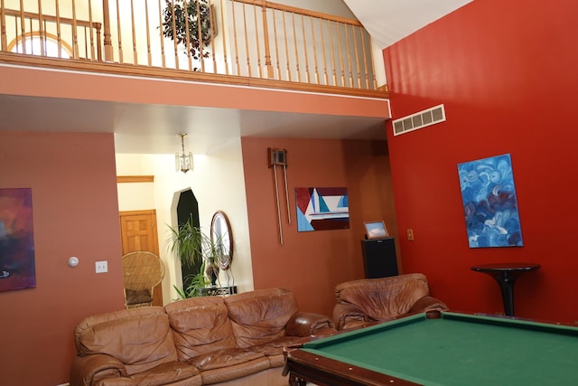 recreation room featuring a towering ceiling and billiards