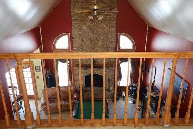 interior space featuring ceiling fan and a brick fireplace