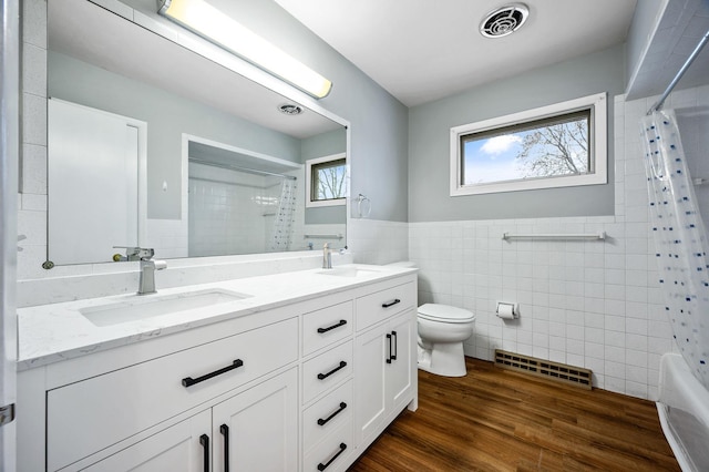 full bathroom with vanity, hardwood / wood-style flooring, toilet, and tile walls