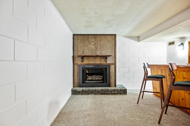 carpeted living room featuring a fireplace