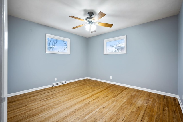 spare room with ceiling fan and light wood-type flooring