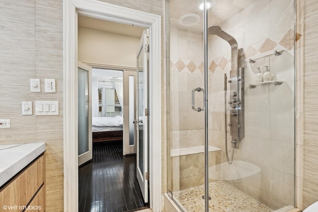 bathroom featuring vanity, tile walls, and an enclosed shower