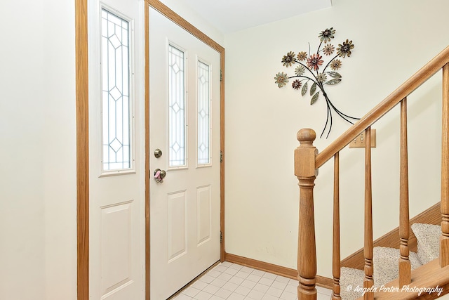 tiled foyer entrance with a wealth of natural light