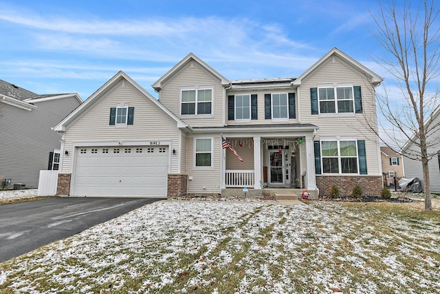 view of front of house featuring a porch and a garage