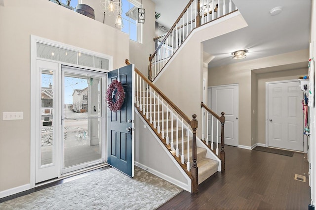 entrance foyer with a high ceiling and dark hardwood / wood-style floors