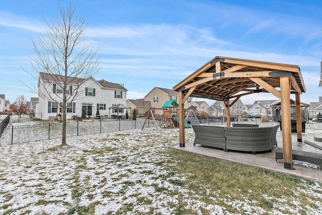 snowy yard featuring an outdoor hangout area and a playground