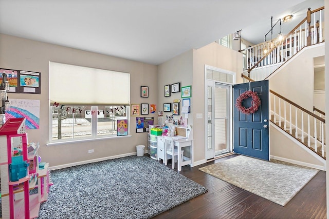 entrance foyer with dark hardwood / wood-style floors and an inviting chandelier