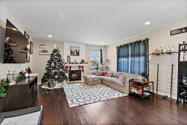 living room with hardwood / wood-style floors and a tiled fireplace