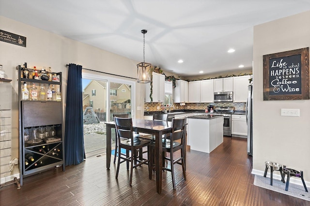 dining area with dark wood-type flooring and sink