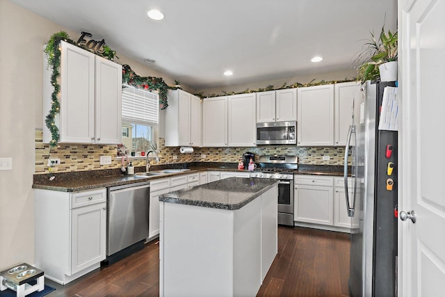 kitchen featuring a center island, stainless steel appliances, dark hardwood / wood-style floors, and sink