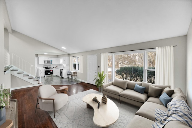 living room featuring dark hardwood / wood-style flooring and vaulted ceiling