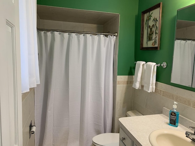 bathroom with toilet, tile walls, vanity, a shower with shower curtain, and backsplash