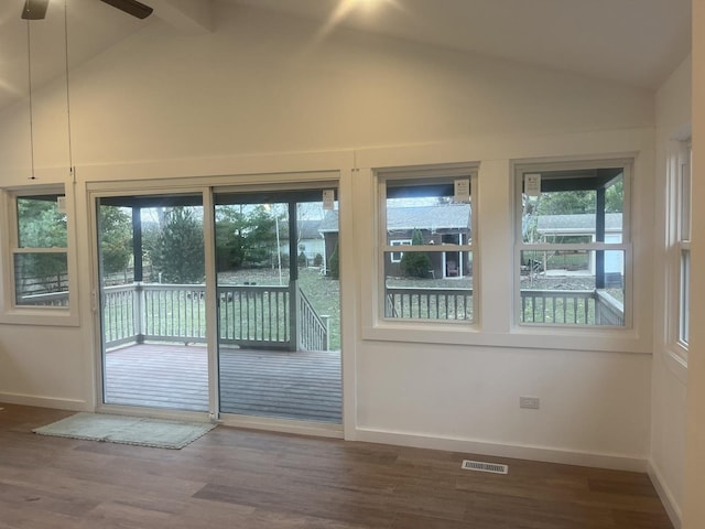 entryway with ceiling fan, dark hardwood / wood-style flooring, and vaulted ceiling with beams