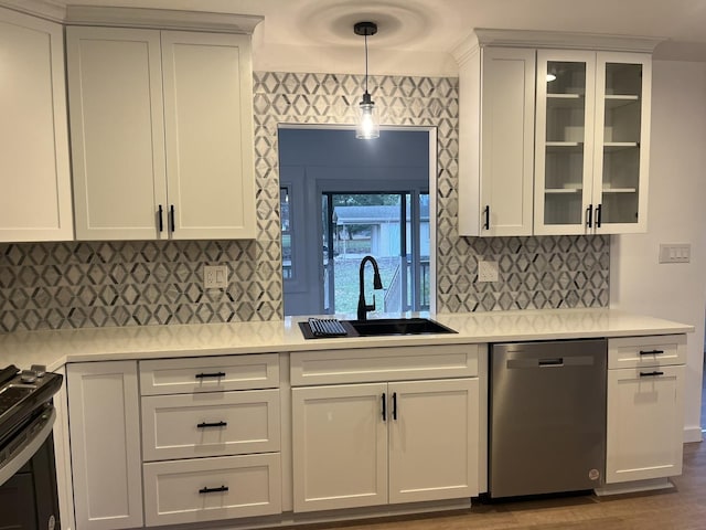 kitchen with white cabinetry, stainless steel dishwasher, sink, black range with electric stovetop, and pendant lighting