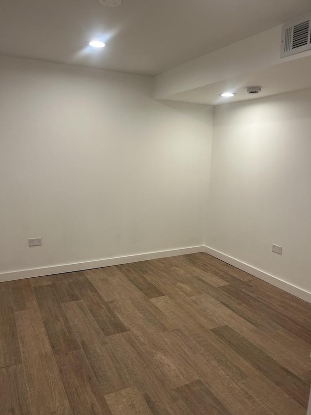 spare room with dark wood-type flooring