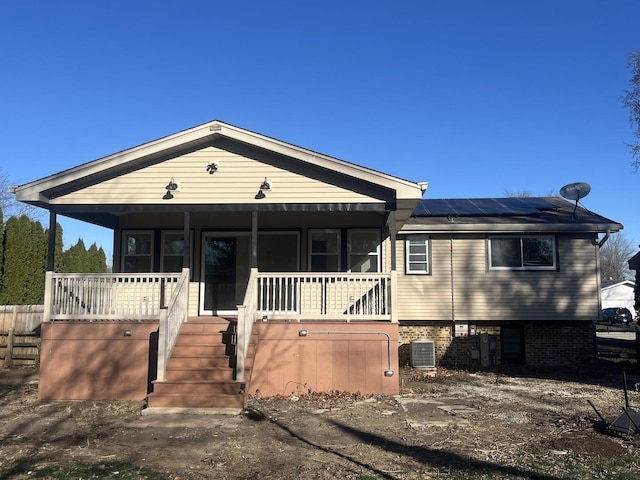 view of front facade featuring covered porch and solar panels