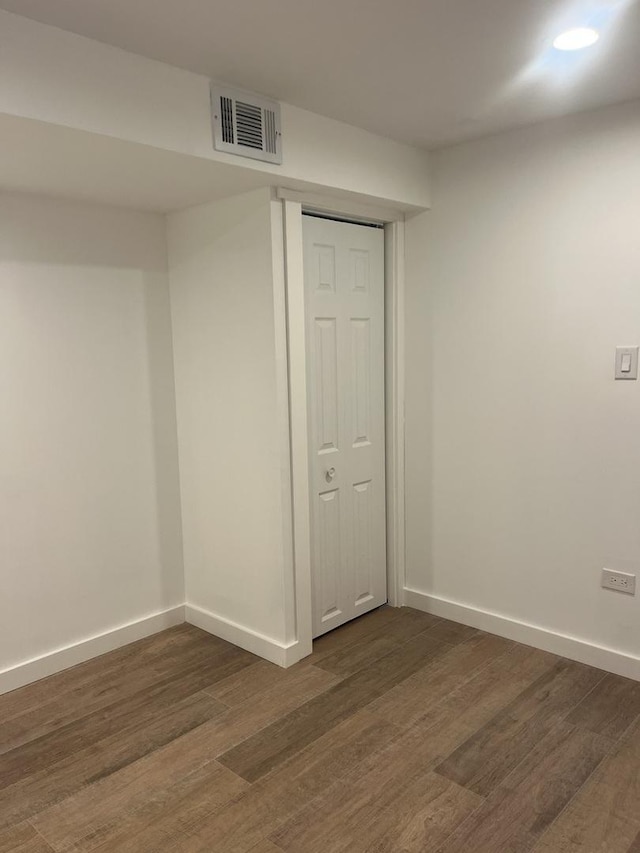 unfurnished room featuring dark wood-type flooring