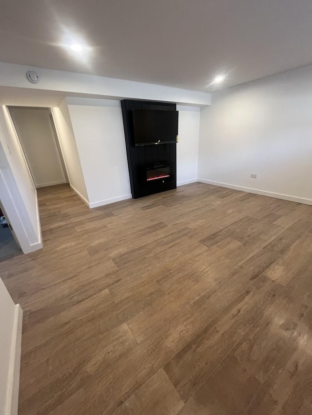 interior space with a fireplace and hardwood / wood-style flooring