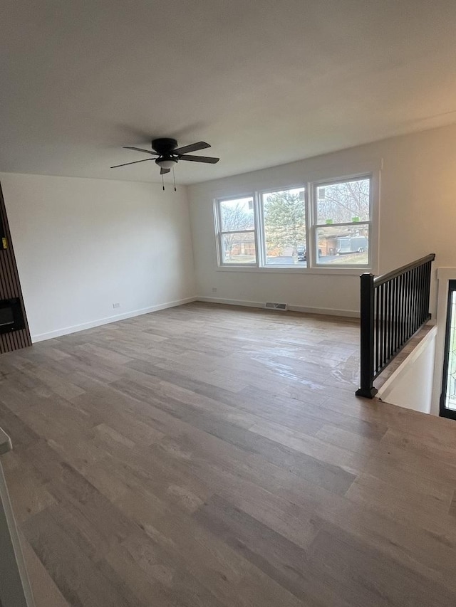 spare room with ceiling fan and hardwood / wood-style flooring