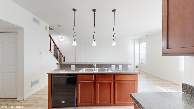 kitchen featuring dishwasher, light hardwood / wood-style floors, sink, and hanging light fixtures