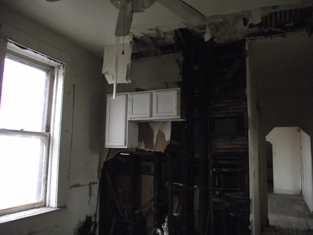 kitchen with white cabinetry and ceiling fan