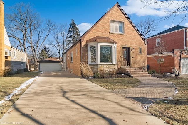 view of front of property featuring an outdoor structure, central AC, and a garage