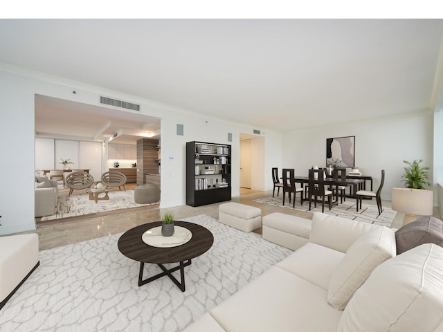 living area featuring marble finish floor, visible vents, and crown molding