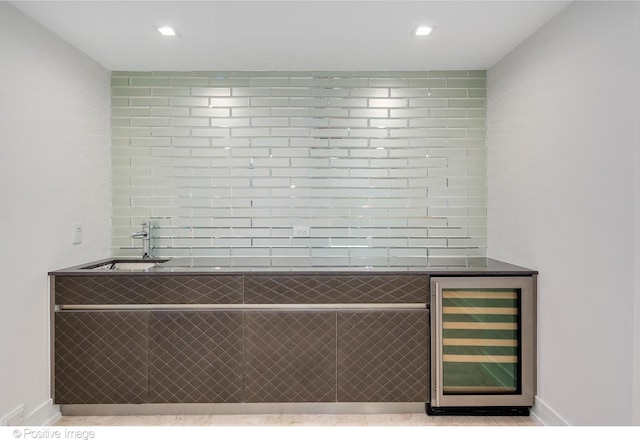 bar featuring wine cooler, a sink, baseboards, and recessed lighting