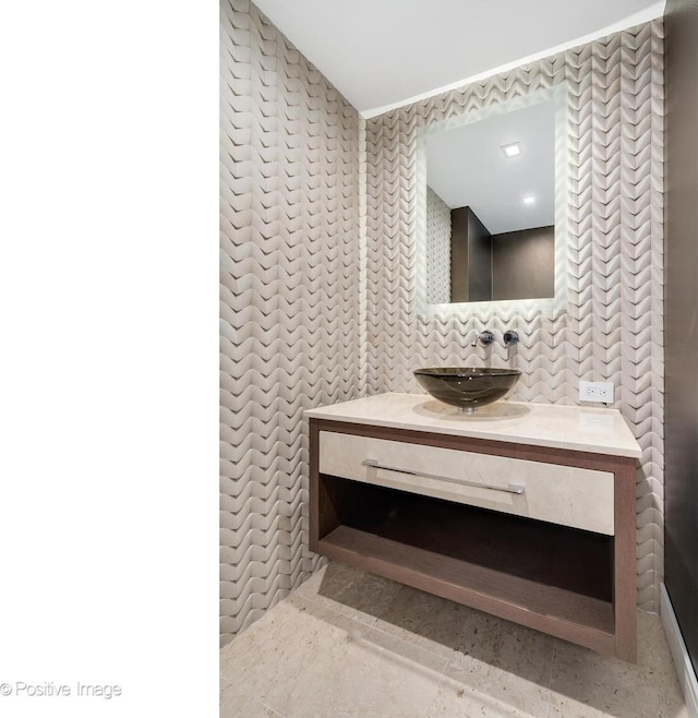 bathroom with vanity and tile walls