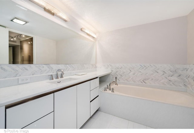 full bath with a garden tub, tile patterned flooring, tile walls, and vanity