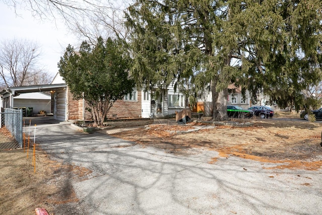 obstructed view of property featuring stone siding and driveway