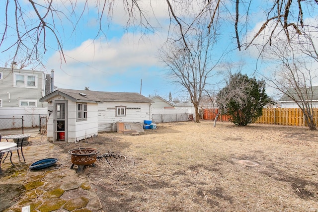 view of yard with a fire pit and a fenced backyard