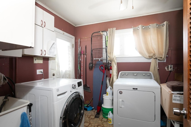 washroom with washer and dryer, cabinet space, and a sink